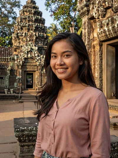 Channary, 26, Cambodian woman from Siem Reap near ancient temple ruins at golden hour