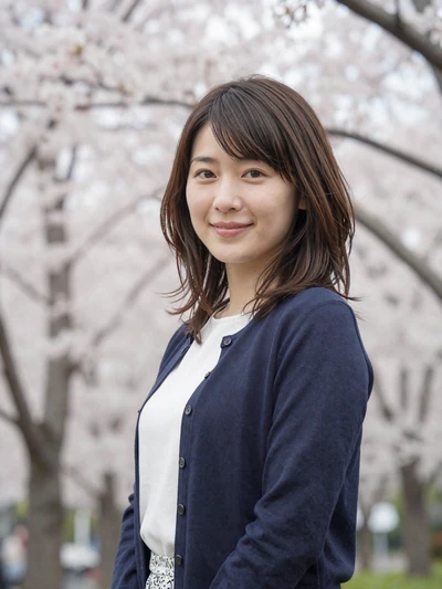 Hana, 31, Japanese woman from Tokyo near cherry blossom trees